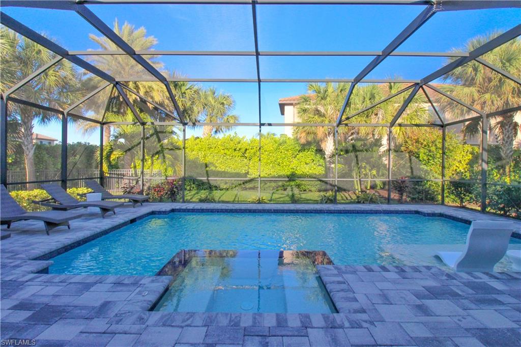View of swimming pool featuring a patio area and a lanai