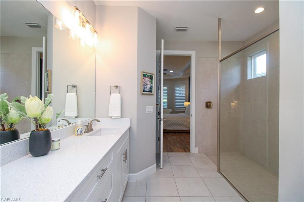 Bathroom featuring tile patterned floors and vanity
