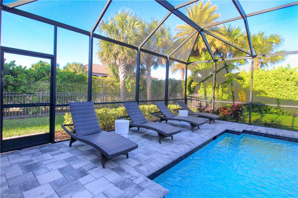 View of swimming pool featuring a lanai and a patio