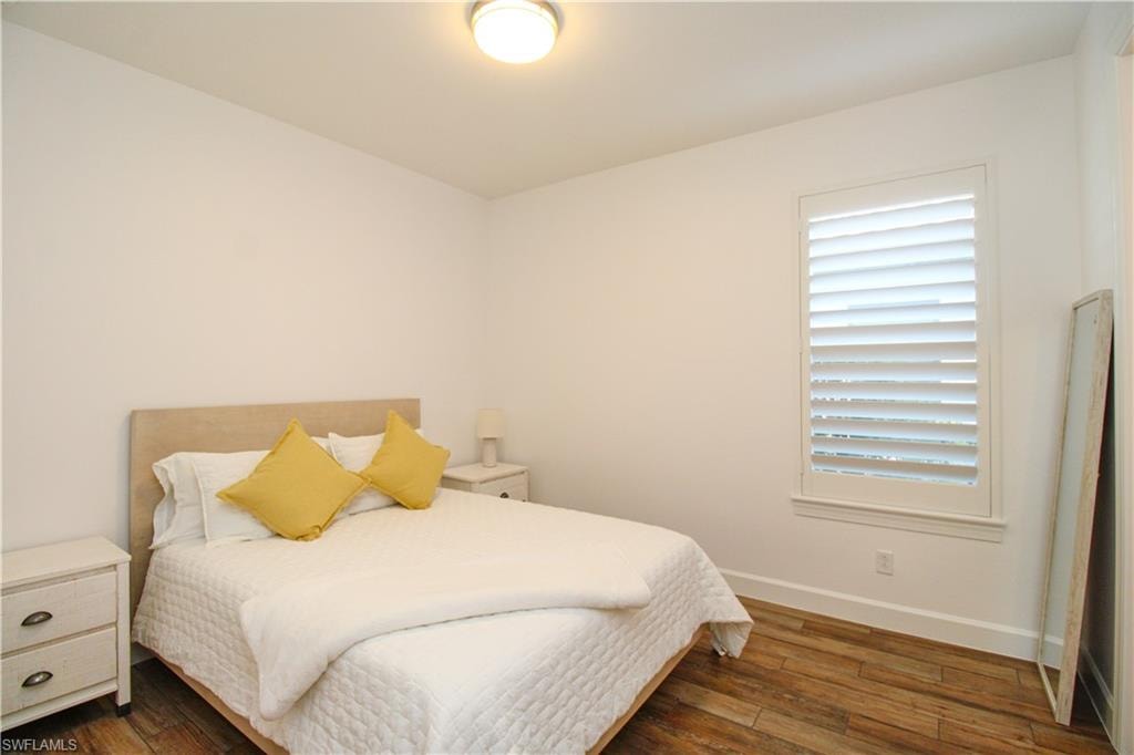 Bedroom featuring dark wood-type flooring