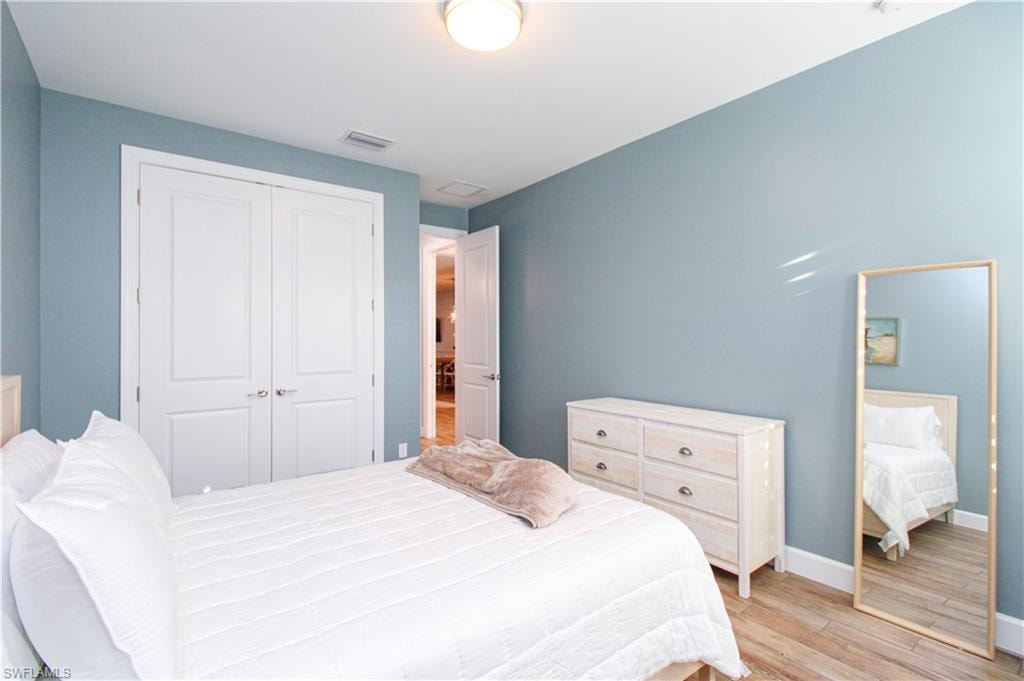 Bedroom featuring light hardwood / wood-style floors and a closet