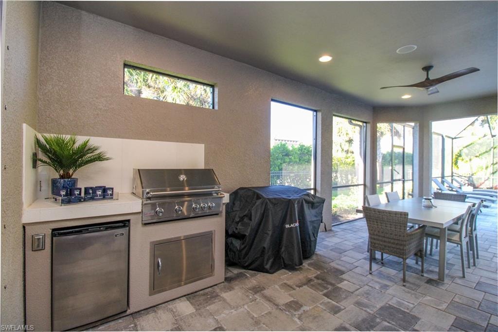 Kitchen with ceiling fan and stainless steel refrigerator