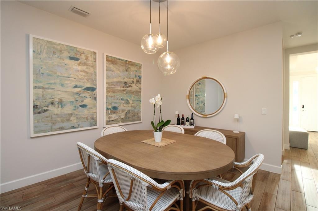 Dining room featuring dark wood-type flooring