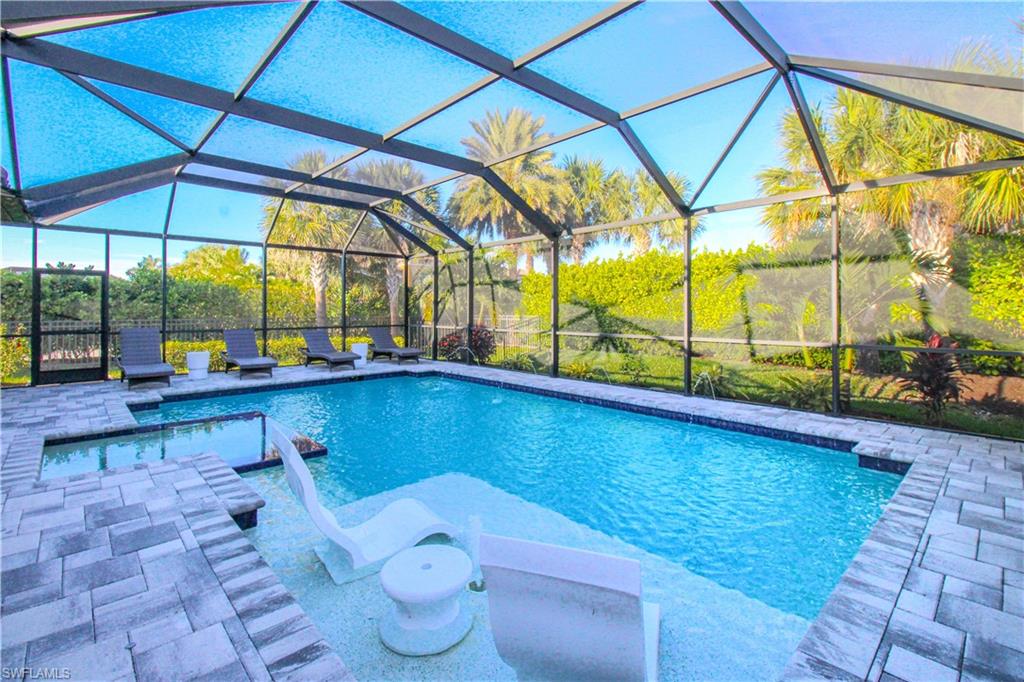 View of swimming pool featuring a patio area and a lanai