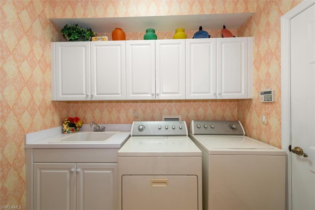 In-home laundry complete with storage cabinets!