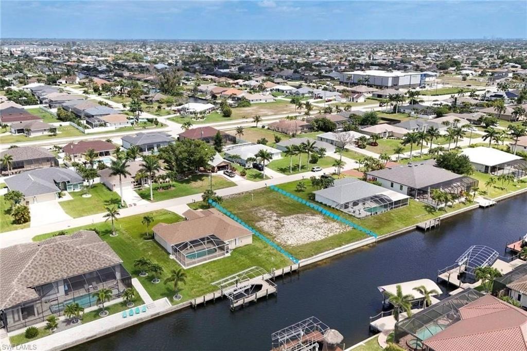 Aerial perspective of suburban area featuring a nearby body of water