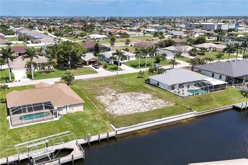 Aerial perspective of suburban area with a nearby body of water