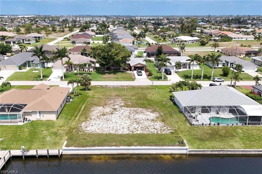 Aerial perspective of suburban area with a nearby body of water