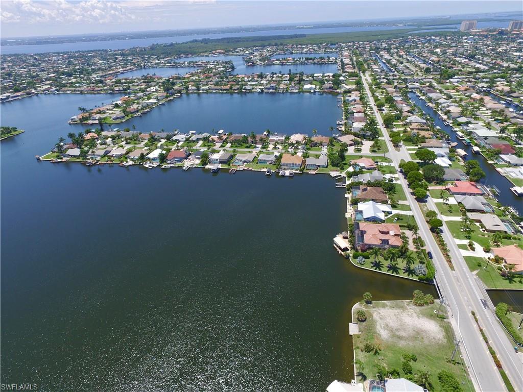 Aerial overview of property's location with a nearby body of water and nearby suburban area