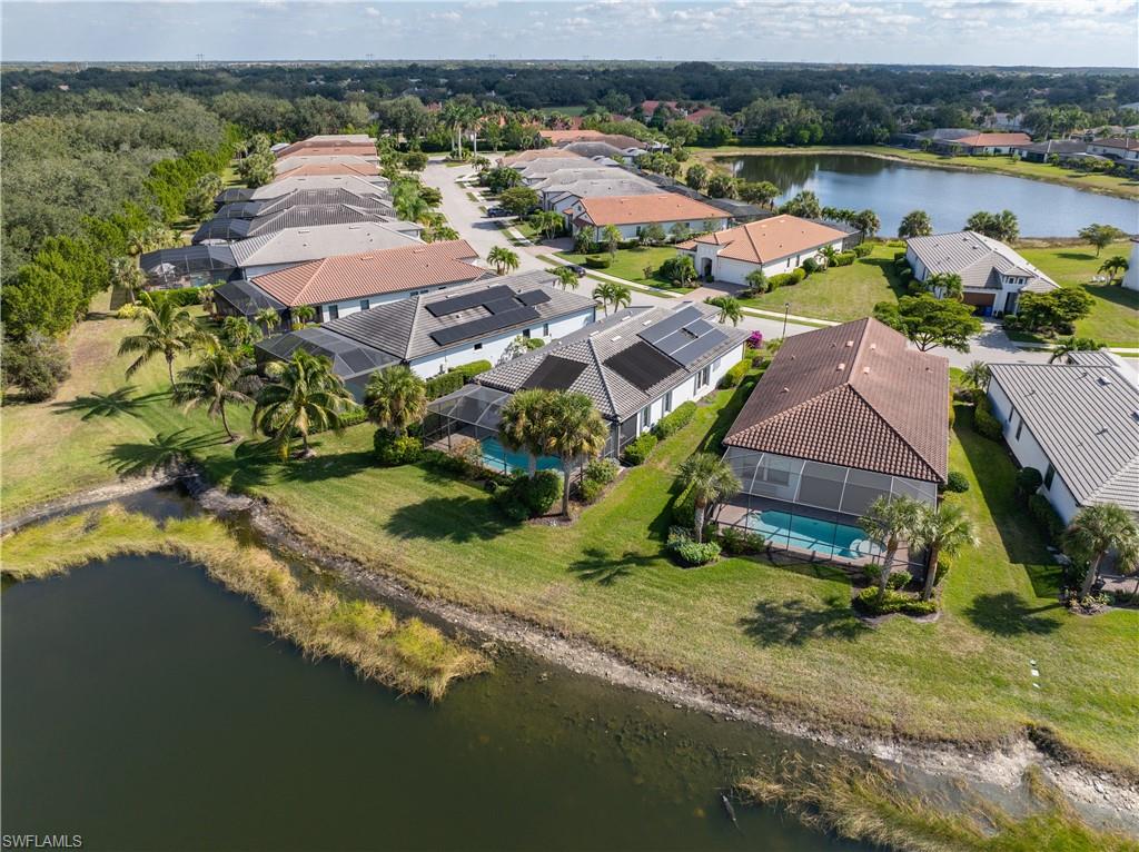 Aerial view of residential area featuring a nearby body of water