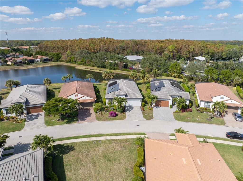 Aerial view of residential area featuring a nearby body of water