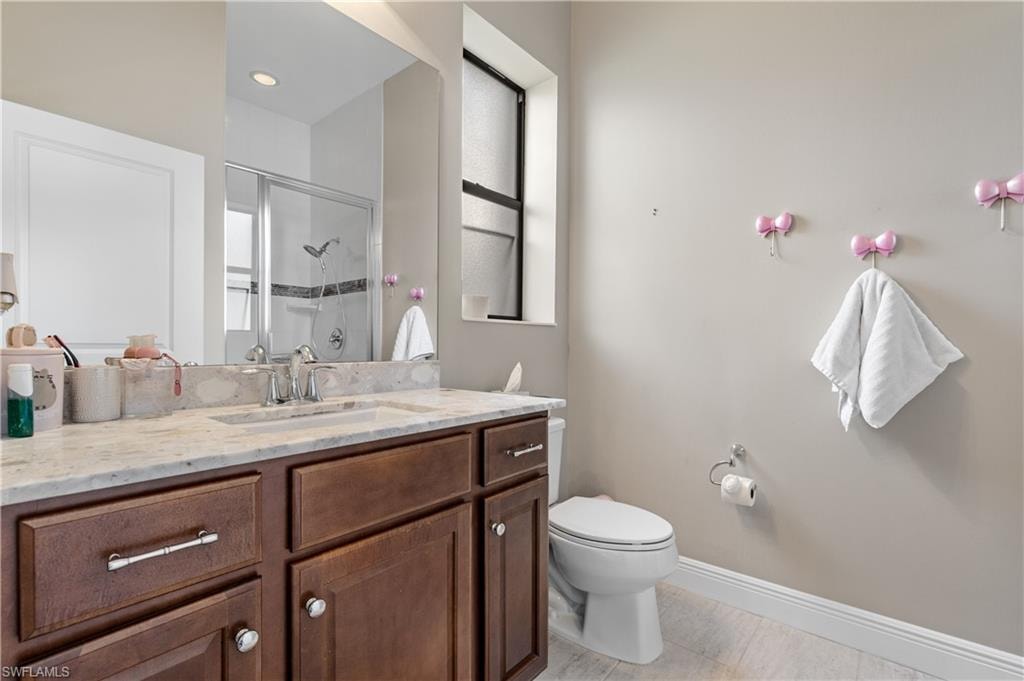 Bathroom featuring vanity, a shower stall, and light tile patterned flooring