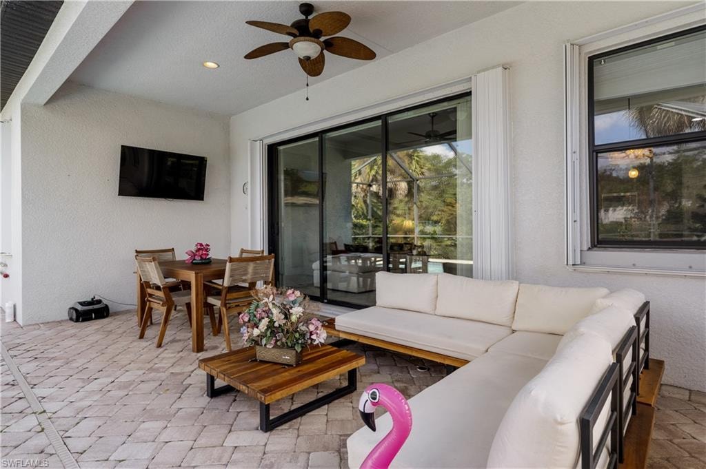 View of patio with ceiling fan, outdoor lounge area, and outdoor dining space