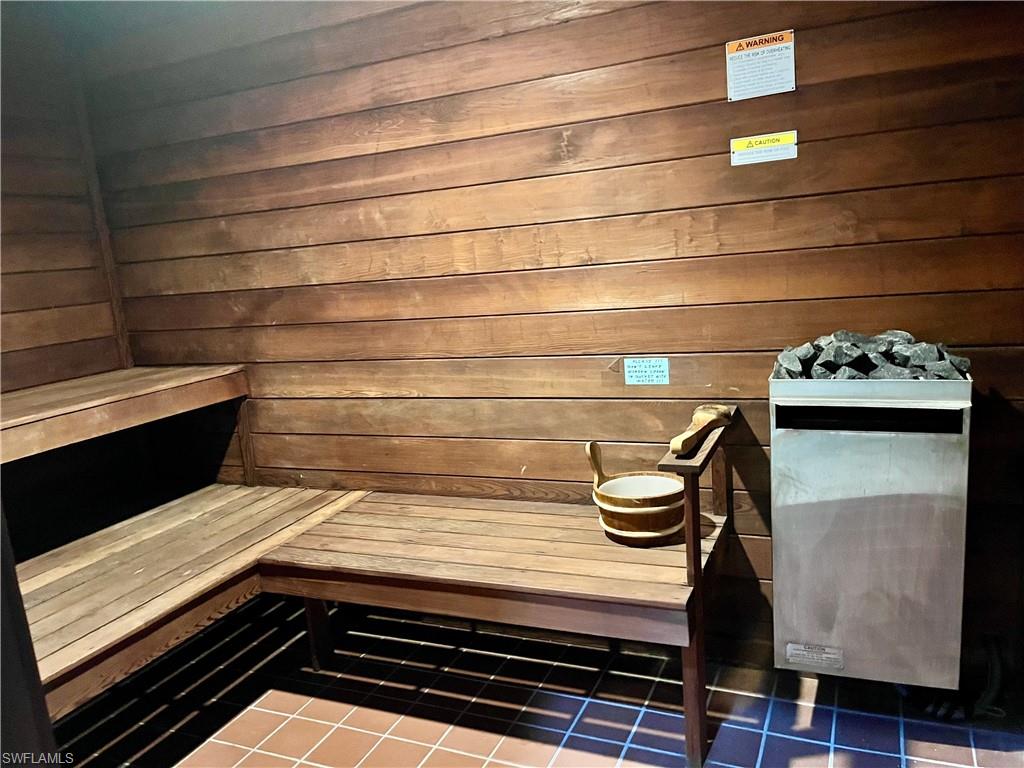 Relaxing sauna / steam room with wooden walls and tile patterned floors