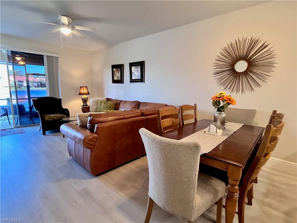 Dining space with a ceiling fan and light wood-style flooring