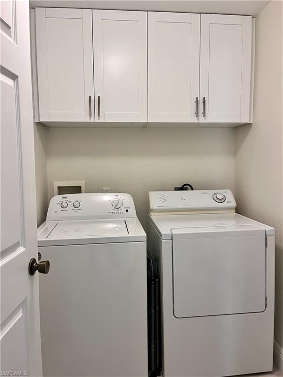 Laundry area featuring washer and dryer and cabinet space