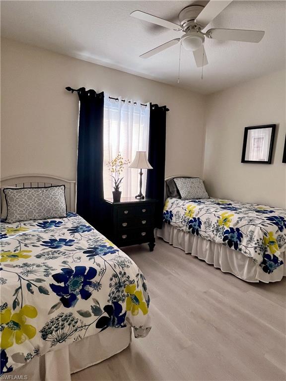 Bedroom with ceiling fan and wood finished floors