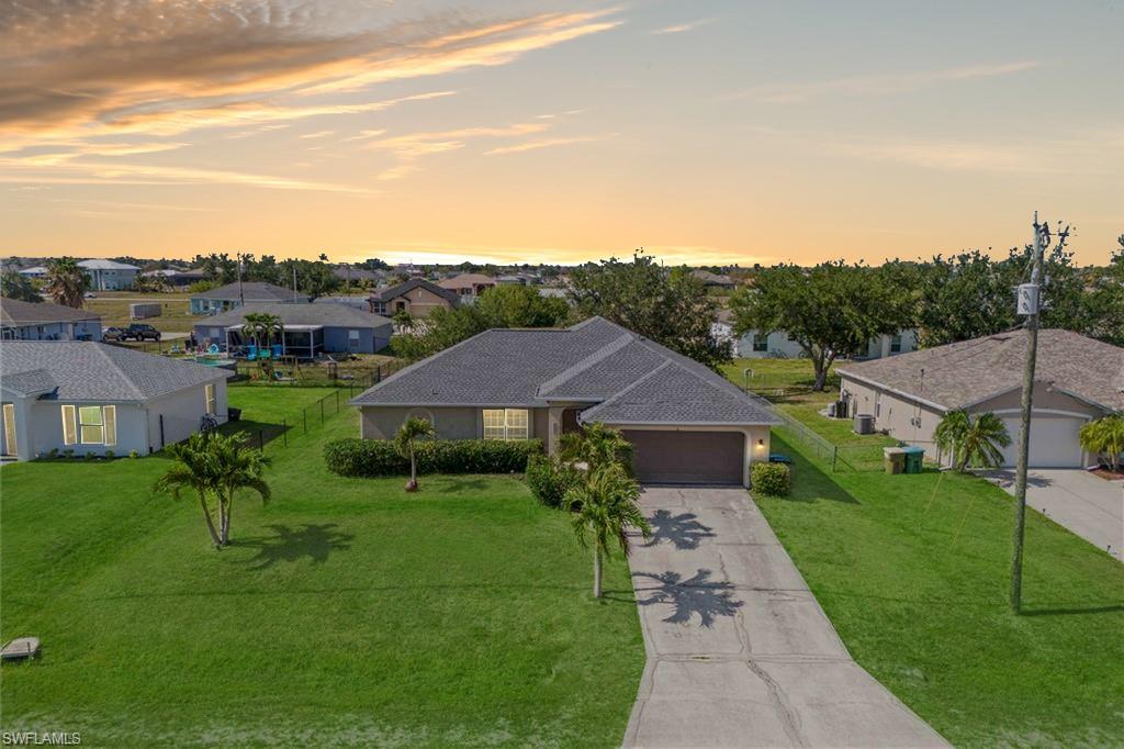 This beautiful pool home offers a private oasis with a sparkling pool, surrounded by lush landscaping.