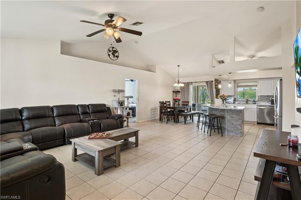 Spacious, open concept living, dinning and kitchen area, with high ceilings and plenty of natural light, creating a welcoming and airy atmosphere.