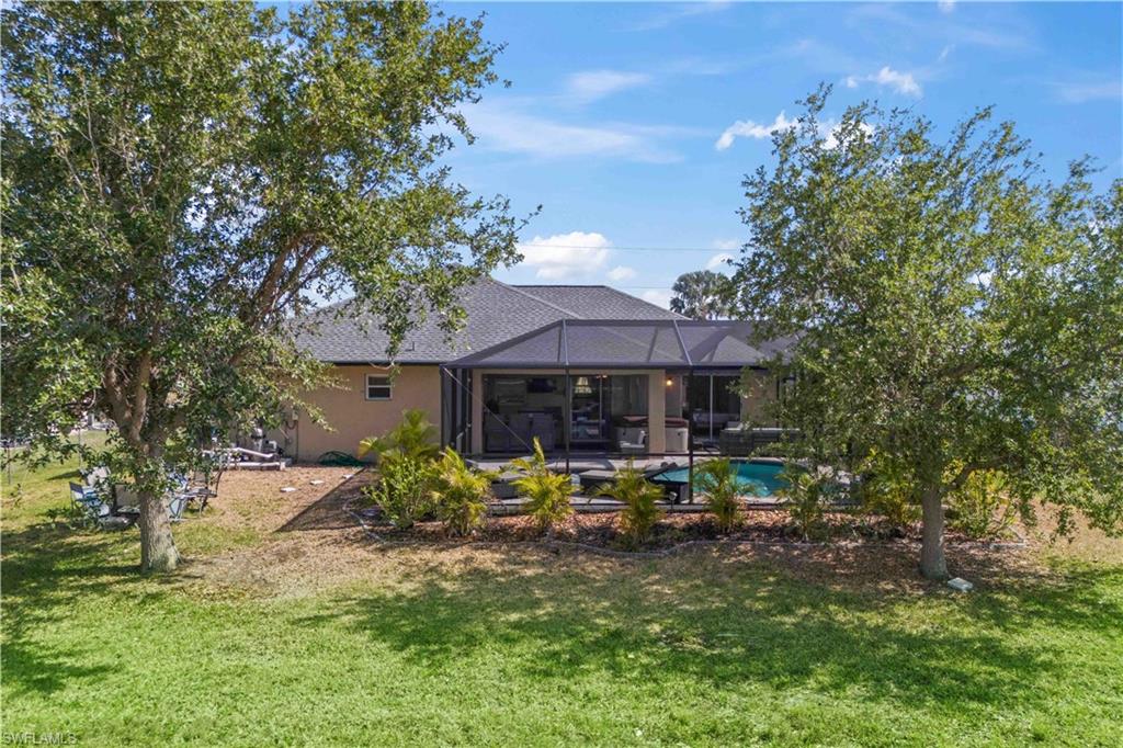 The huge backyard is a private sanctuary, surrounded by lush greenery that creates a serene and secluded atmosphere.