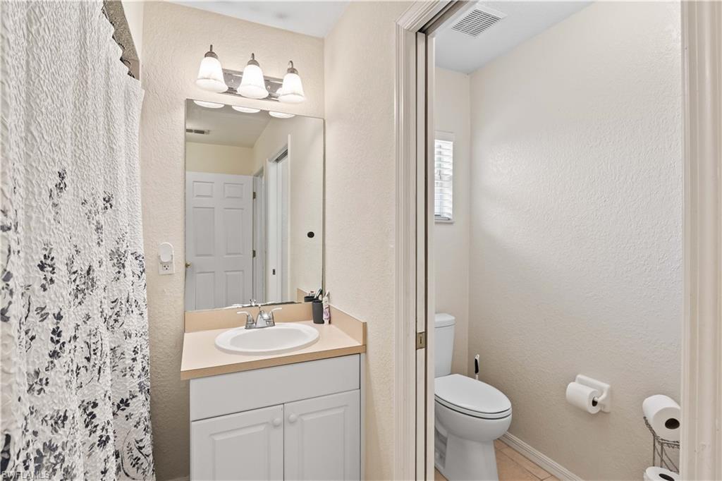 The guest bathroom offers privacy and a relaxing retreat, featuring a beautiful shower and tub combination.