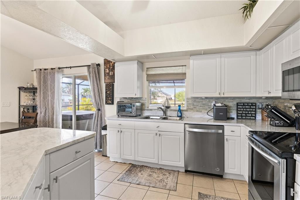 The kitchen boasts a window offering a beautiful view of the pool, creating a serene and inviting atmosphere as you cook.