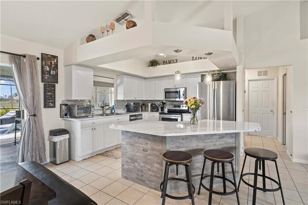 The open design allows natural light to flood the space, making the kitchen feel bright and airy.