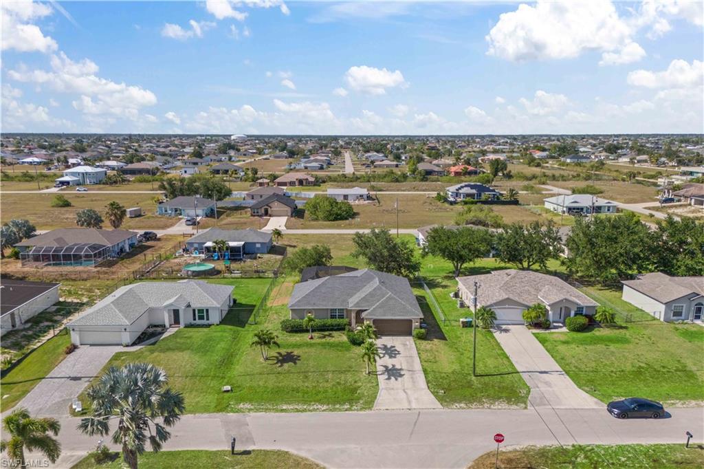 The aerial view of the community reveals a tranquil, well-planned neighborhood with tree-lined streets and beautifully maintained homes.