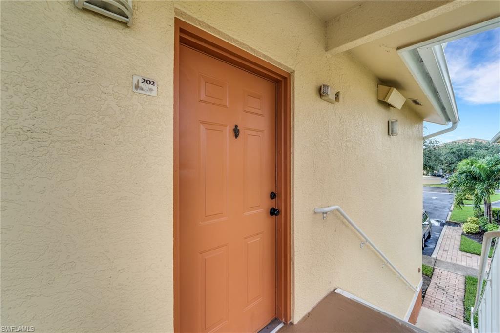 Entrance to property with stucco siding