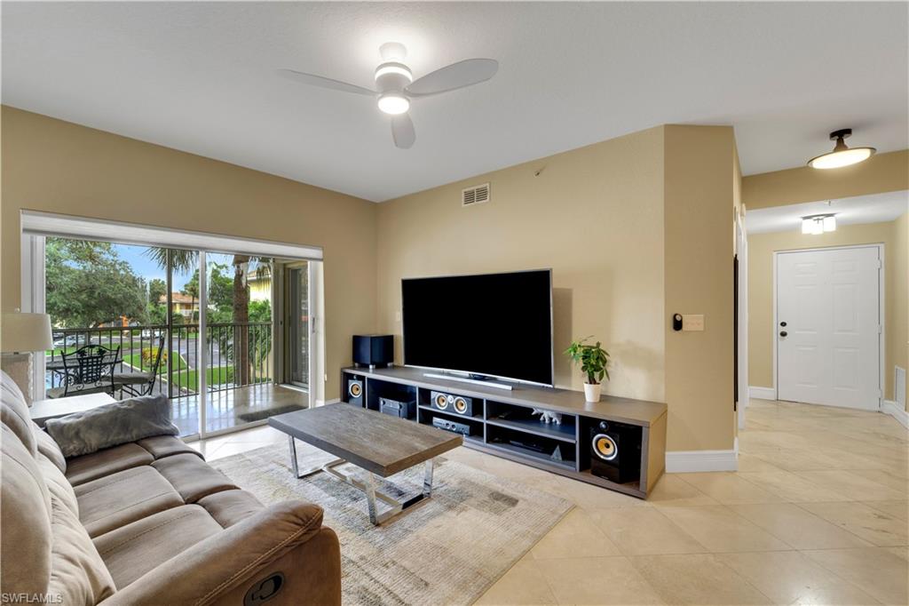 Living area with light tile patterned floors and a ceiling fan
