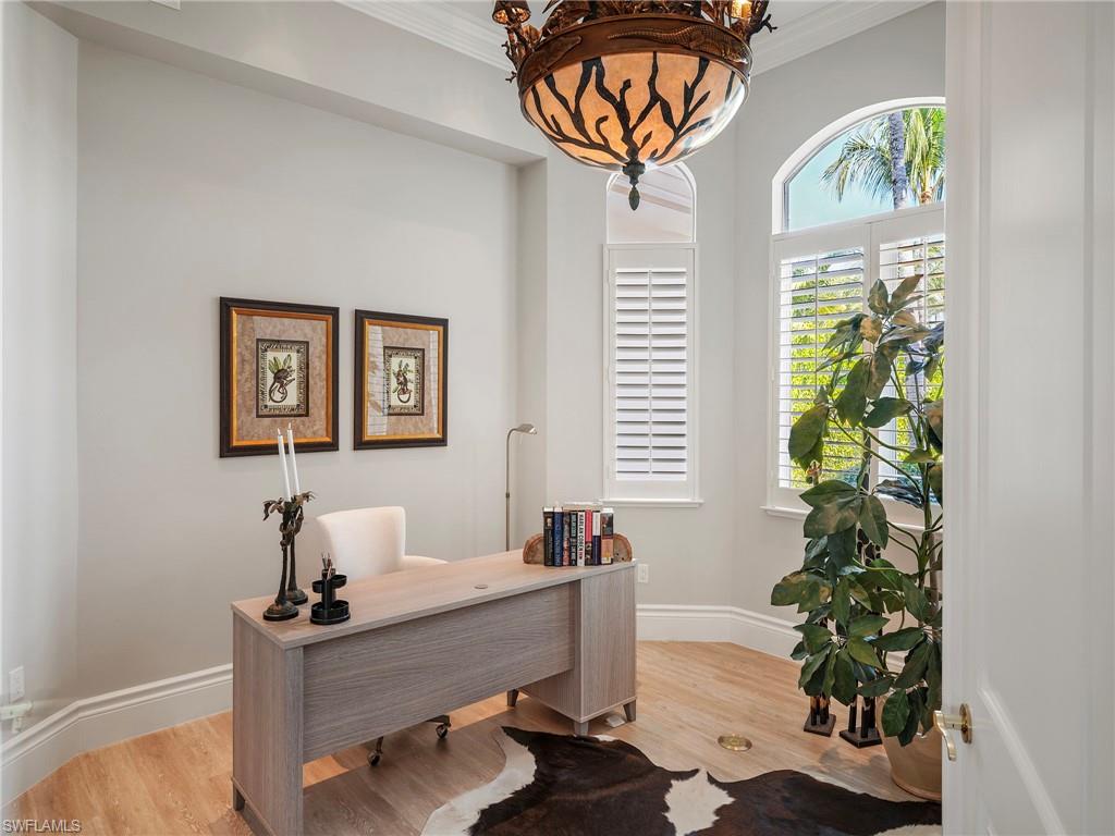 Office space featuring light wood-type flooring and ornamental molding
