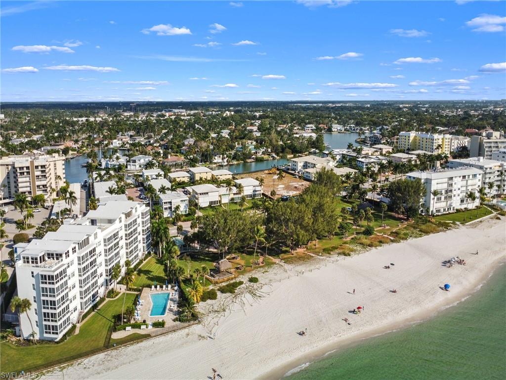 View of urban area with expansive beach and apartment complex / building