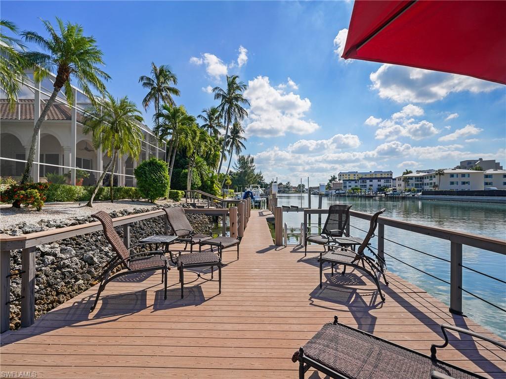 Dock area featuring a deck with water view and a lanai