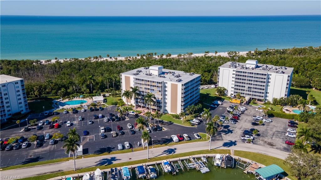 Drone / aerial view of a nearby body of water and apartment complex