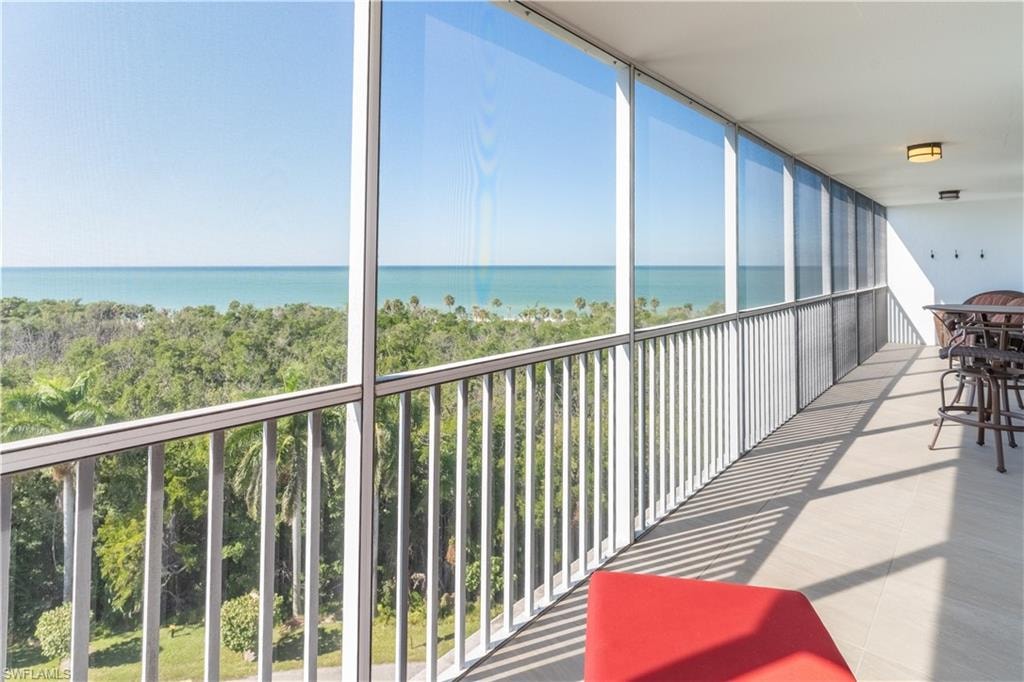 Balcony with a sunroom and a water view