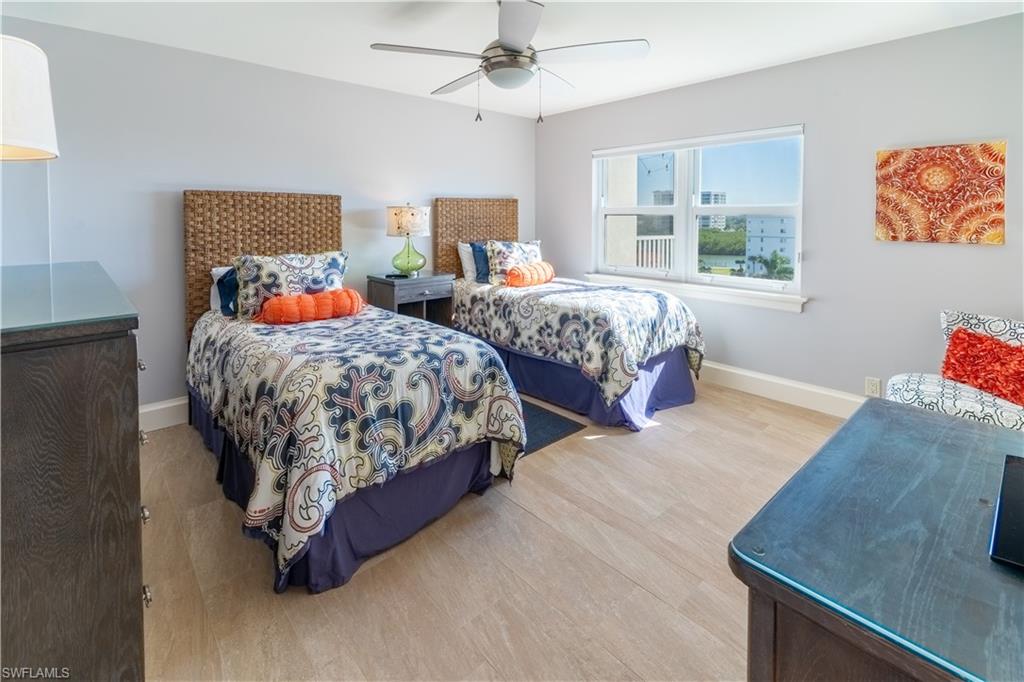 Bedroom with light wood-style floors and a ceiling fan