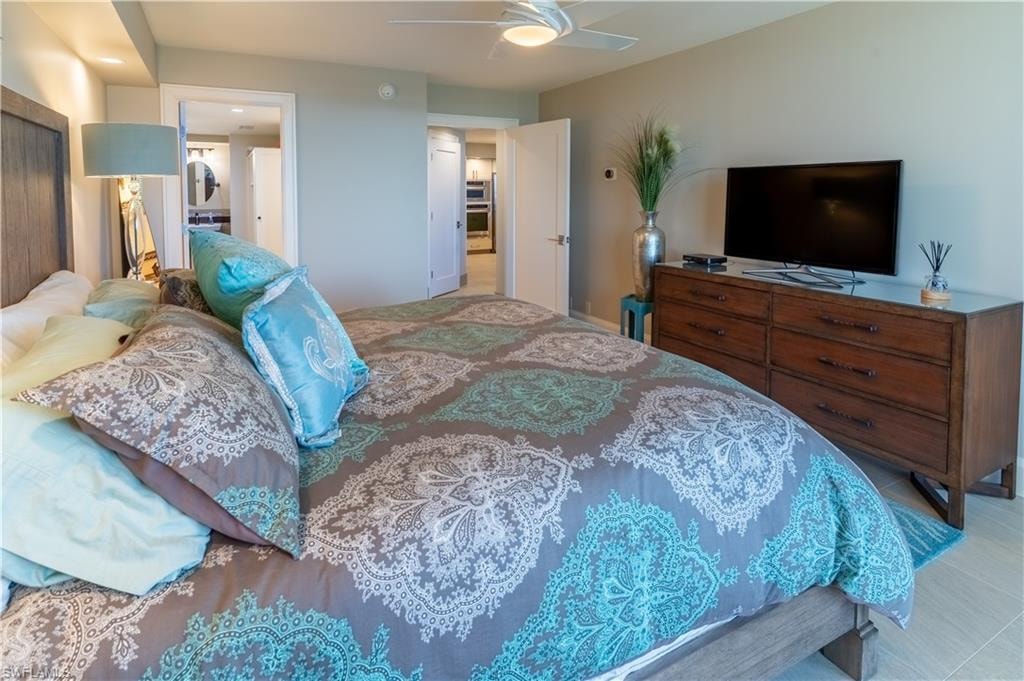Bedroom featuring ensuite bathroom and a ceiling fan