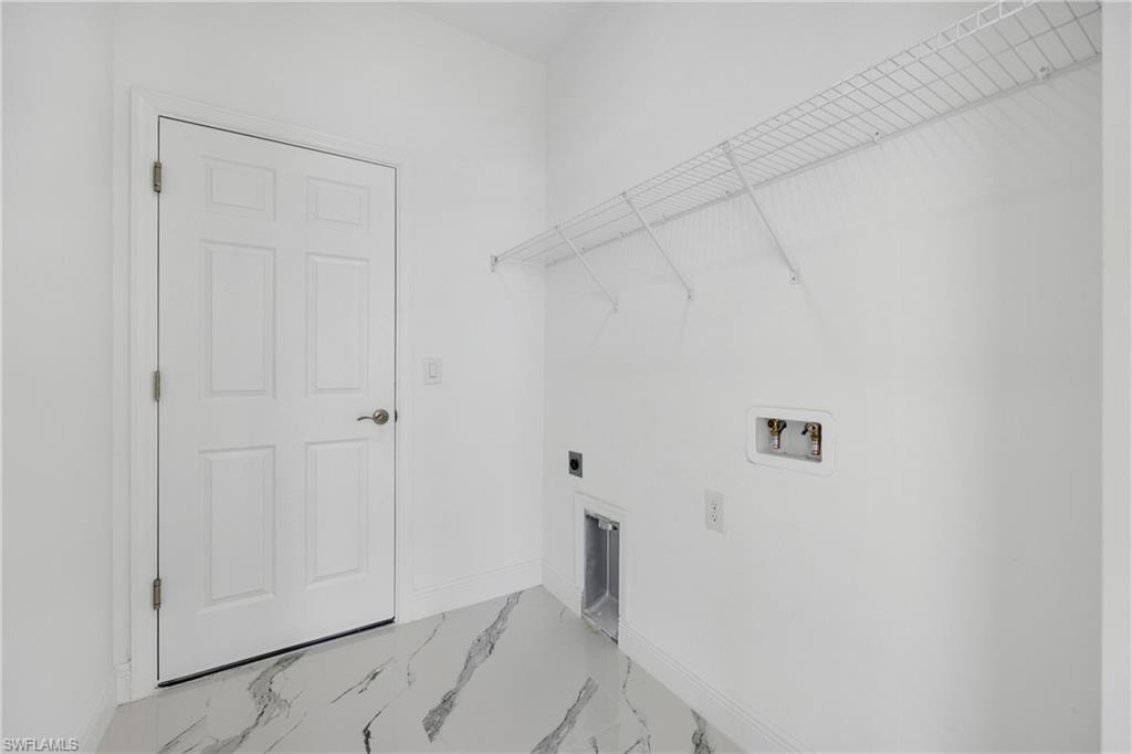 Laundry area featuring hookup for a washing machine, marble finish flooring, and electric dryer hookup