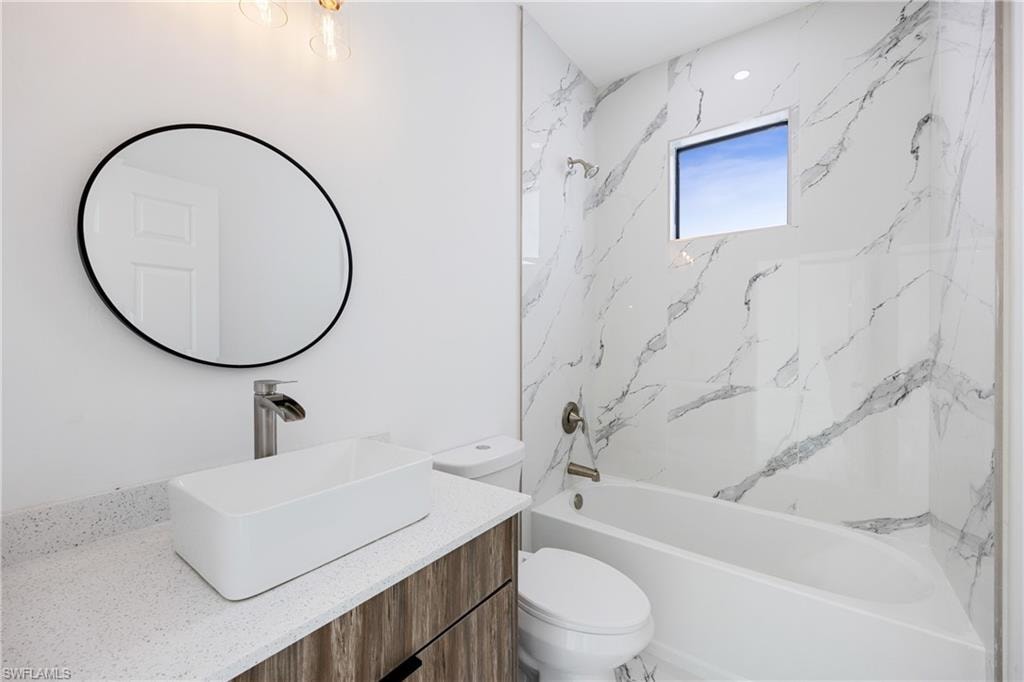 Bathroom with vanity and shower / washtub combination