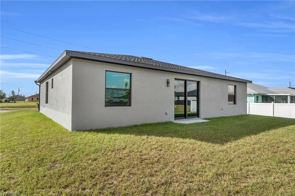 Back of property featuring stucco siding