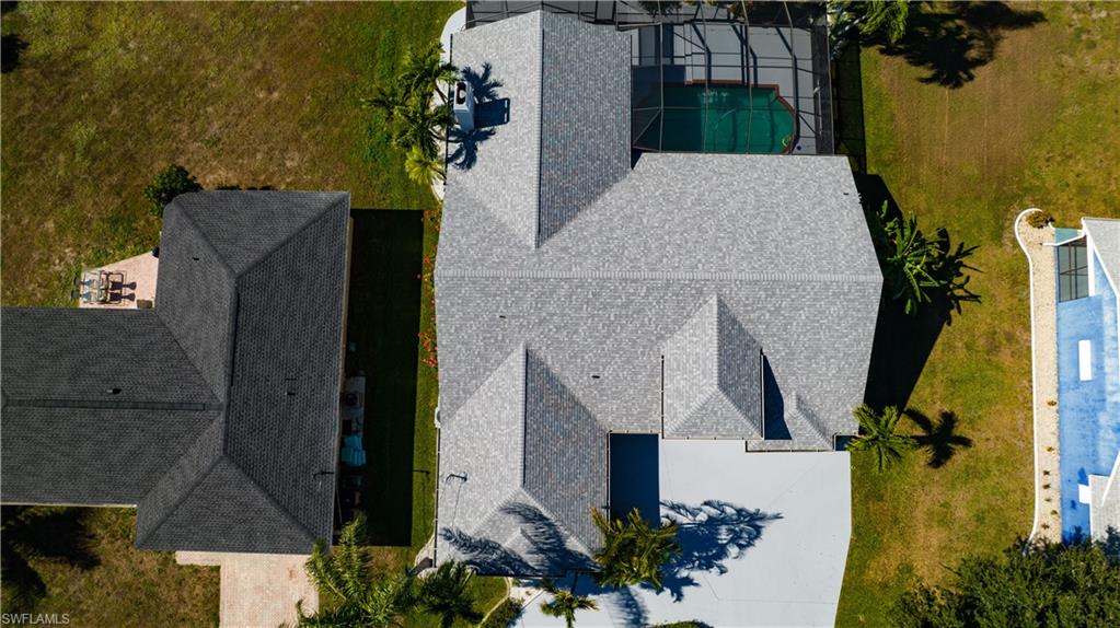 Aerial view of property and surrounding area with a pool