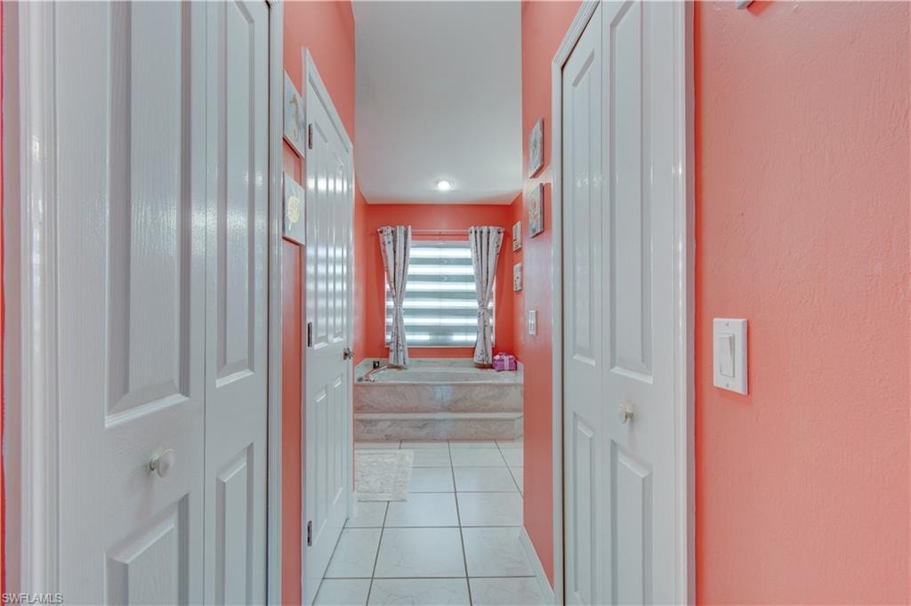 Hall with light tile patterned floors