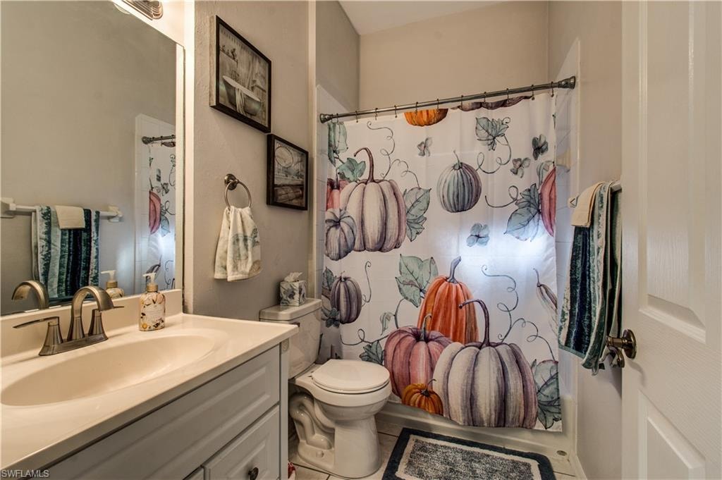 Full bathroom with vanity and shower / bath combo with shower curtain