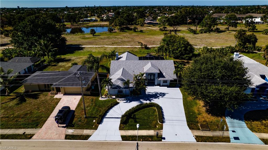 Aerial perspective of suburban area featuring a nearby body of water