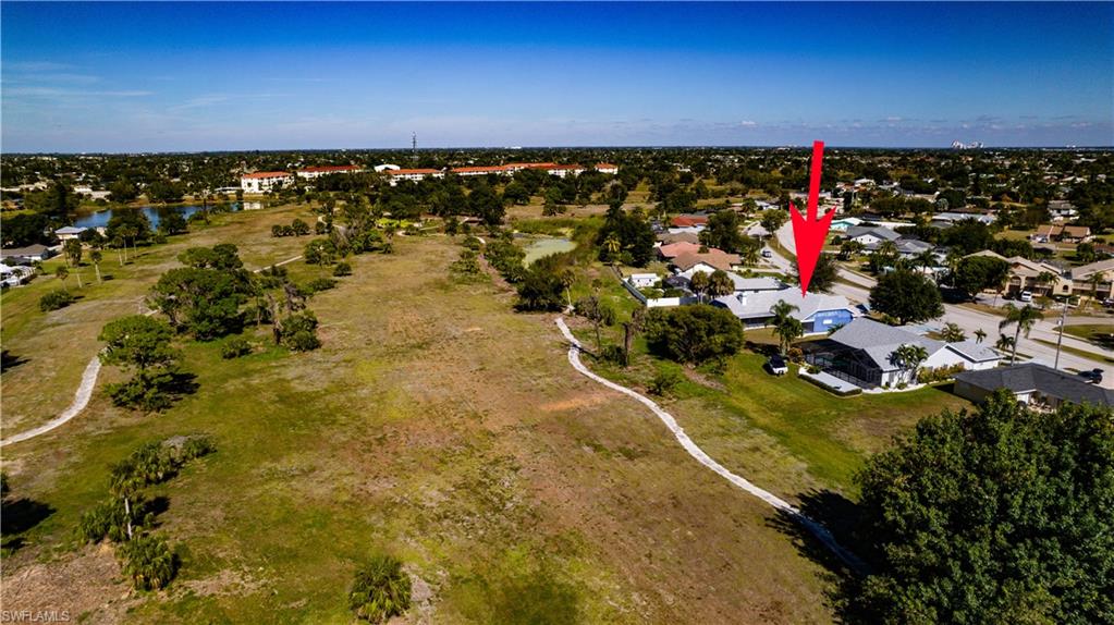 Aerial overview of property's location with a nearby body of water
