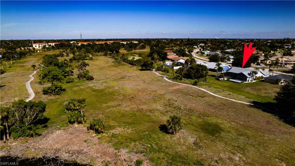 Aerial overview of property's location featuring nearby suburban area