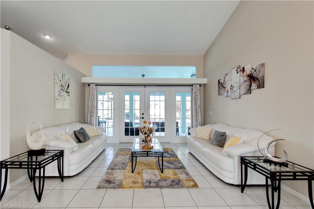 Living room featuring french doors and light tile patterned floors