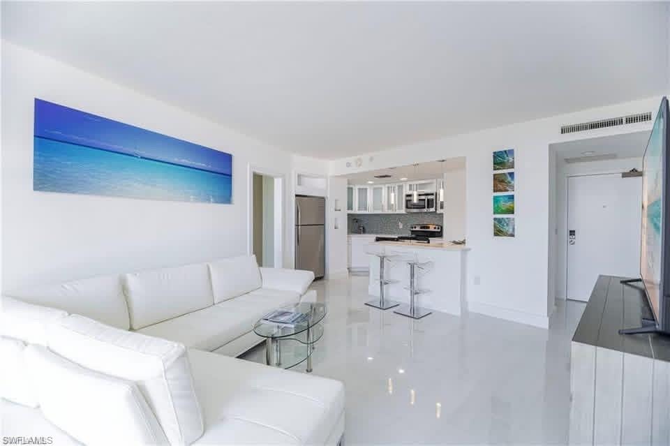 View of open living area featuring marble style flooring, designer touches throughout