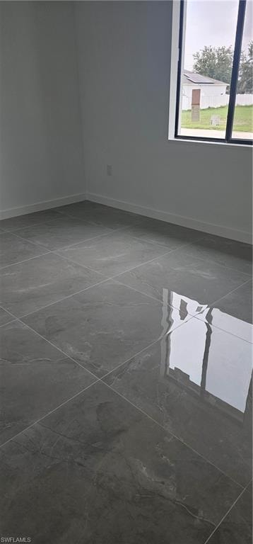 Empty room featuring baseboards