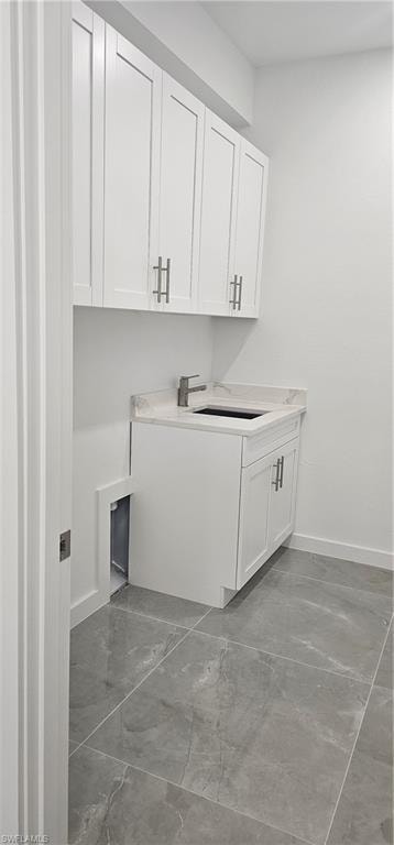 Washroom with light marble finish flooring and baseboards